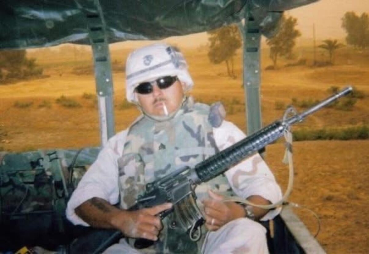 Joseph C. Gomez in desert camouflage during a deployment to Iraq